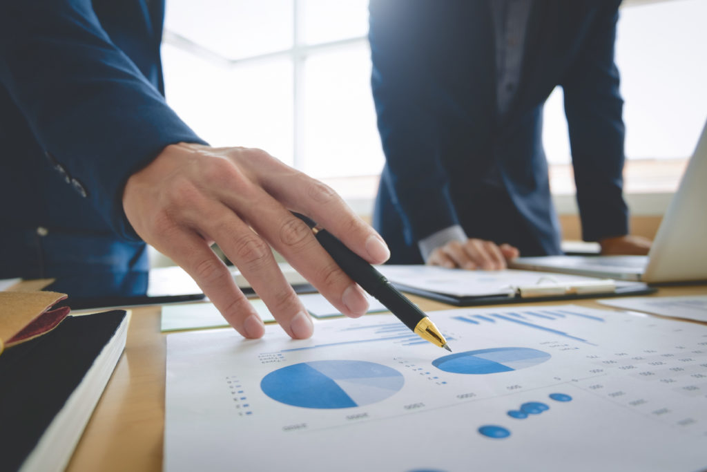 two Business executives partner analysis data document with accountant at office place Business Stats 2